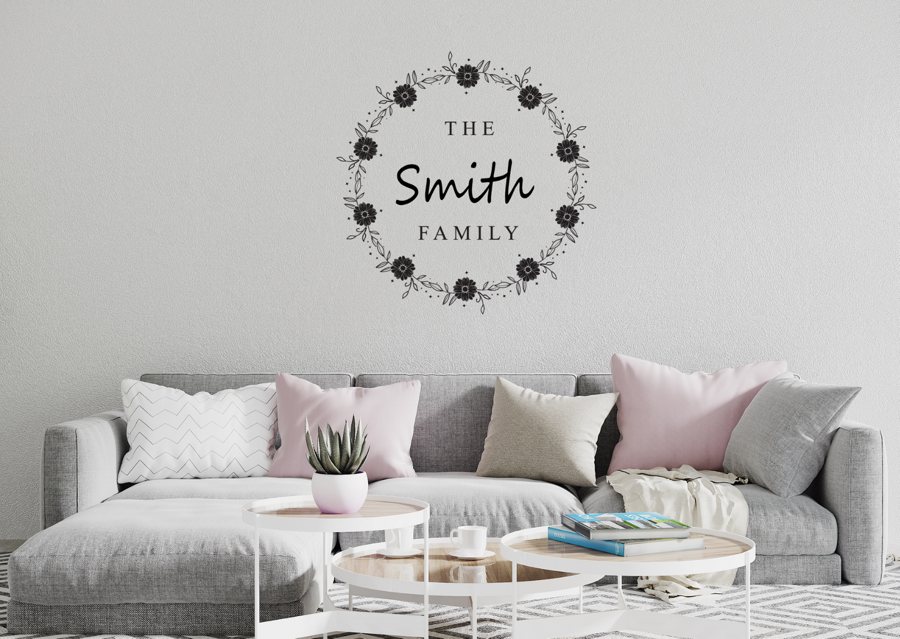 A family name wall sticker in a wreath design above a sofa (mock up)